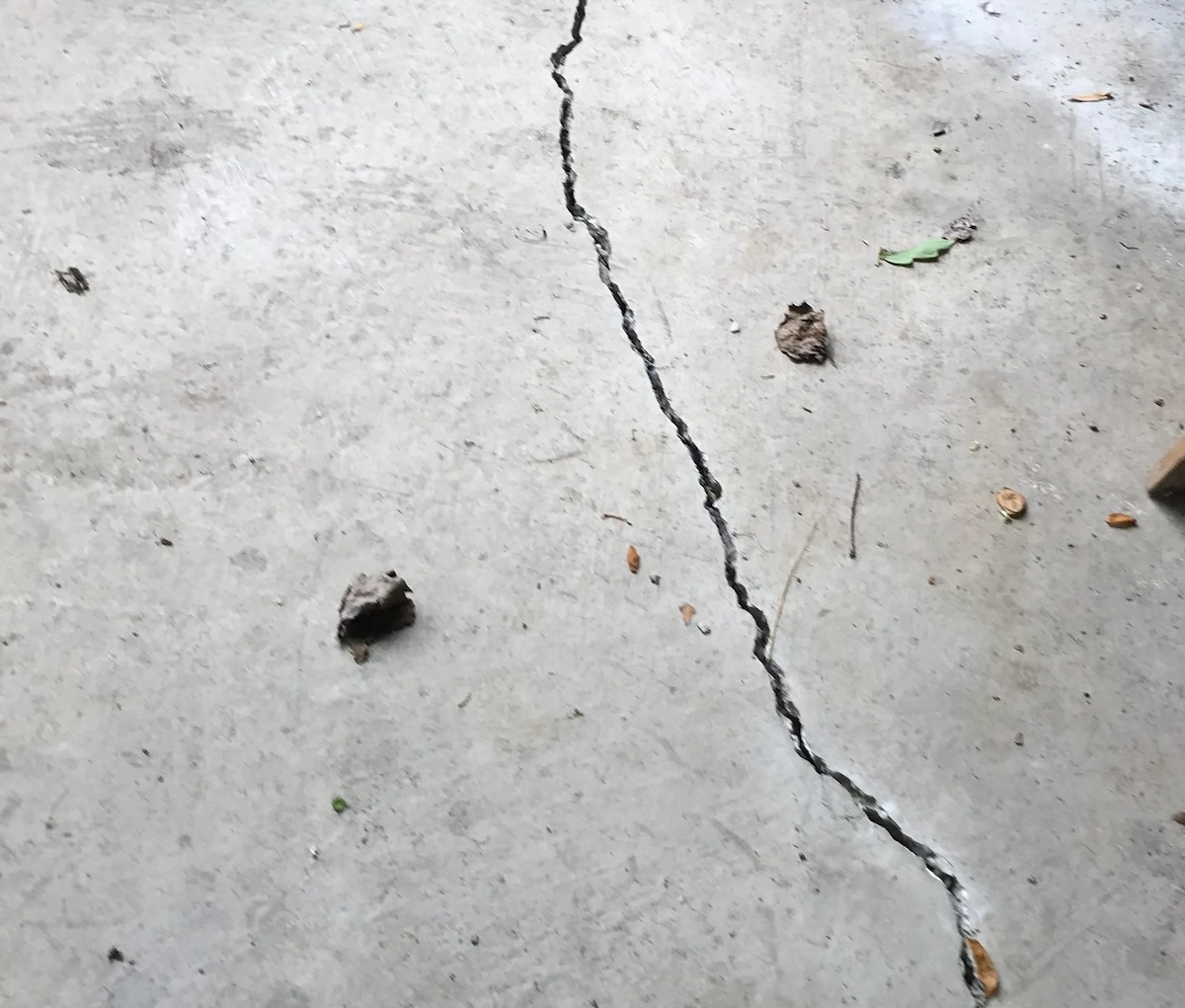 Close up of a floor crack in a garage.