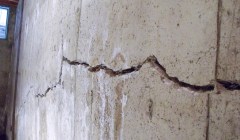 Close up of a crack in a bowing basement wall.