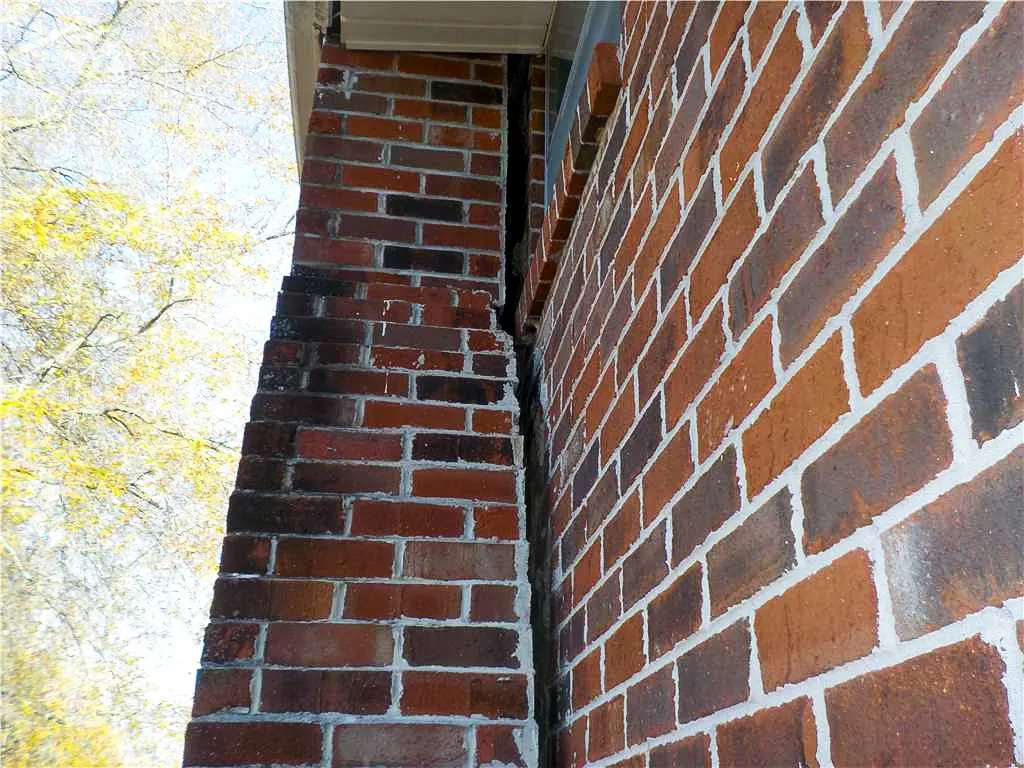 Exterior photo of a chimney separating on a brick home.