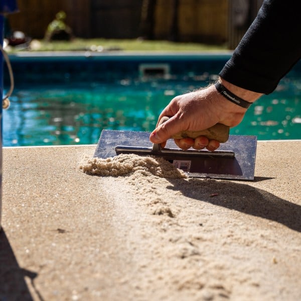 Crack in pool deck concrete being fixed