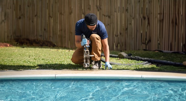 Groundworks tech repairing concrete on pool deck