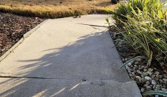 An uneven sidewalk on the exterior of a home.