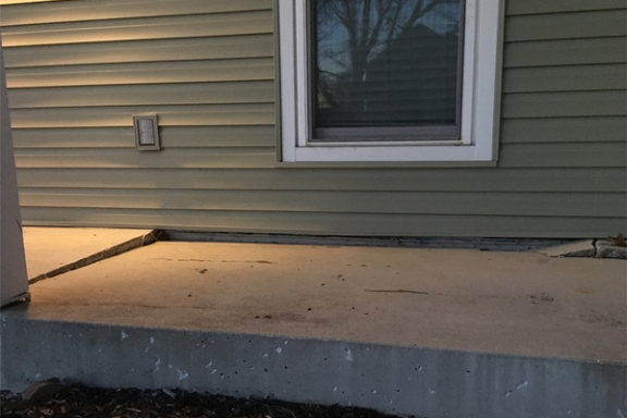 view of a home with lifting concrete porch