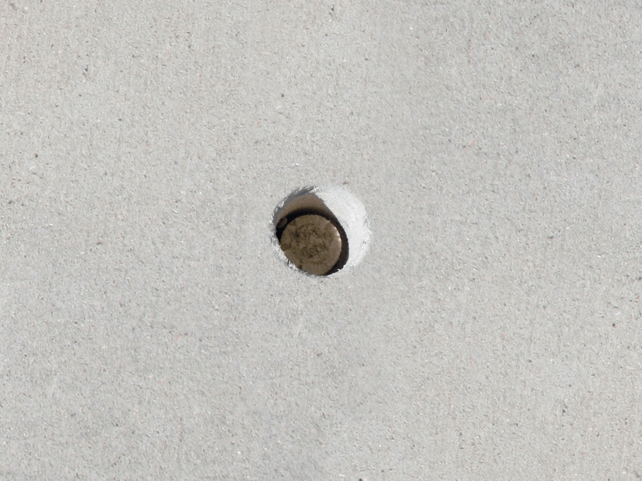 small hole drilled into concrete to repair