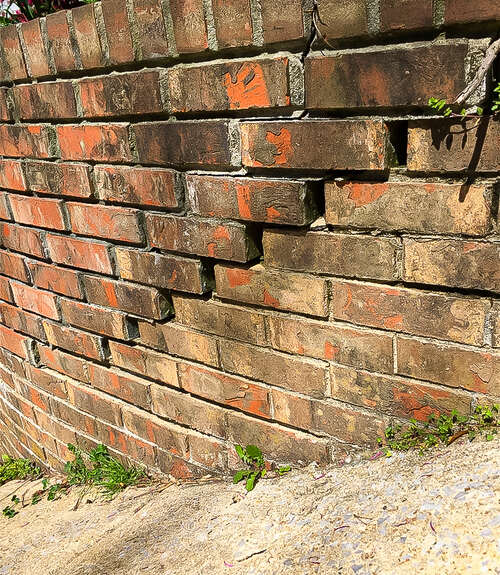 Cracked bricks outside on brick wall in need of foundation repair