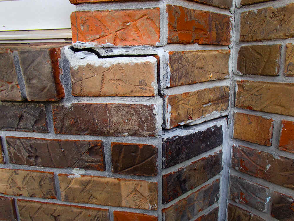 Cracked bricks outside on brick wall in need of foundation repair