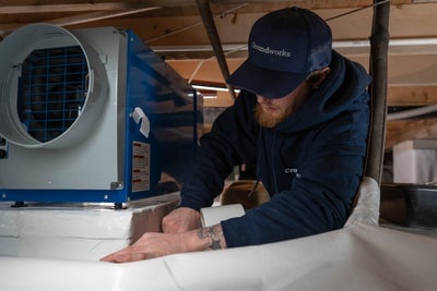 Crawl space dehumidifier being installed