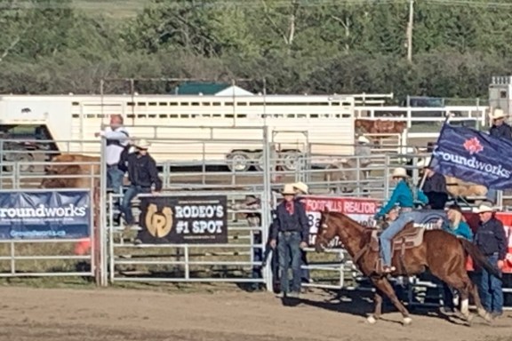 Man rides on horse with Groundworks flag