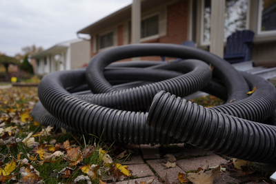 drains piled up on the side yard and deciding between weeping tile and French drains 